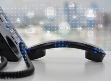 IP Phone double exposure with blue LED world map and business icon of VOIP human and  for communication concept